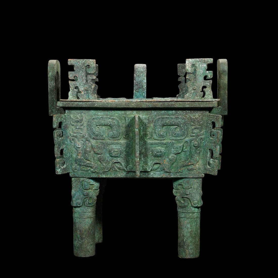 Bronze Covered Square Ding with Beast?Mask Motifs: Bronze Covered Square Ding with Beast?Mask MotifsPeriod: Late Shang?Early Western ZhouDimensions: Height 40?cm (15.75?in), Width 37?cm (14.57?in)Inscription: Long cast?inscription on inner base wallCo