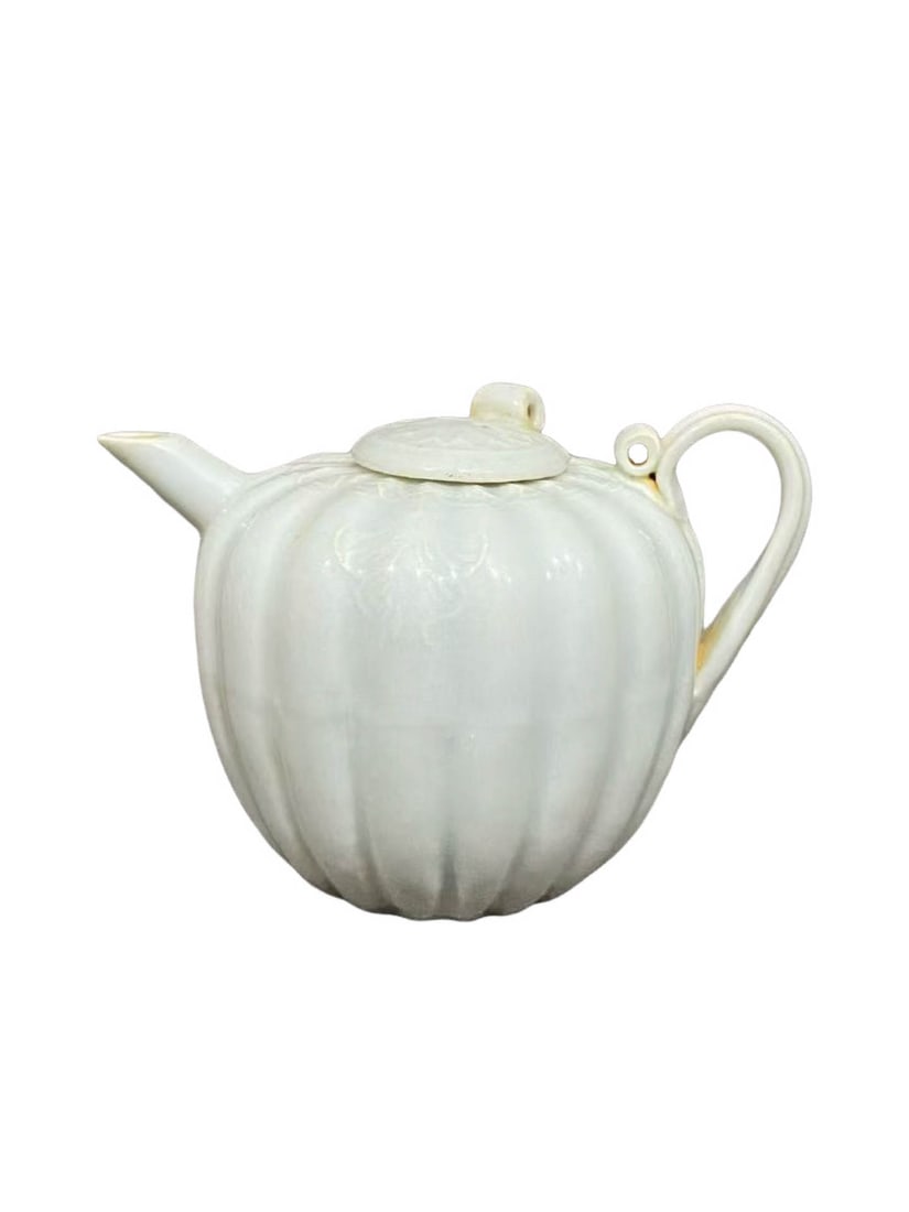 Yingqing?Glazed Melon?Ribbed Ewer: Yingqing?Glazed Melon?Ribbed EwerSuggested Period: Song?Yuan Dynasty, Hutian Kiln GroupDimensions: Width 2.68 in, Height 2.17 inObject DescriptionMaterial & CraftsmanshipThis melon?ribbed ewer was