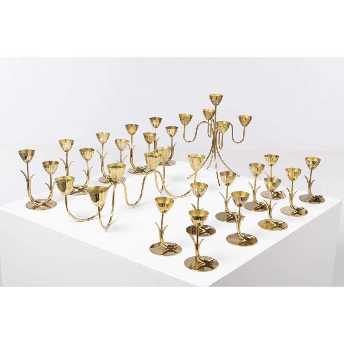 Gunnar Ander (1908-1976) Set of candleholders: Gunnar Ander (1908-1976)Set of candleholdersGolden brassEdited by Ystad MetallModel created circa 1950Monogrammed, signed beneath the baseTen simple candleholders, five double candleholders, one cente