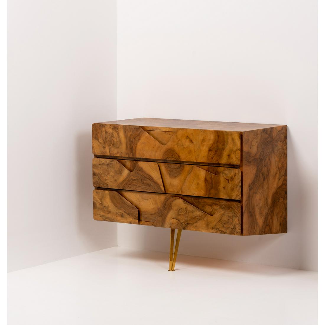 Gio Ponti (1891-1979) Radica: Gio Ponti (1891-1979)RadicaWall-mounted chest of drawersWood, olive wood veneer and brassManufactured by Giordano ChiesaModel created circa 1953H 80 × L 100 × P 47 cmBibliography:- Gio Ponti