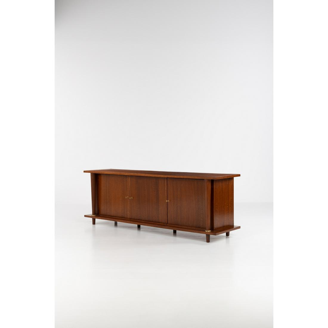 Jean Royère (1902-1981) Sideboard: Jean Royère (1902-1981)SideboardAshwood and brassModel created c. 1950H 84 × L 245 × W 60 cmBibliography: Jean Royère, Galerie Jacques Lacoste et Galerie Patrick Seguin, 2012, Volu