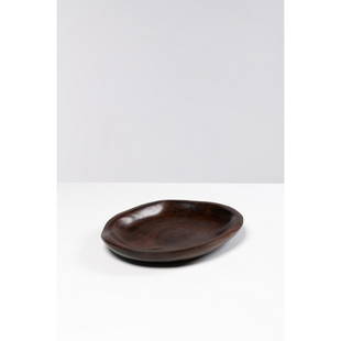 Alexandre Noll (1890-1970) Plate: Alexandre Noll (1890-1970)PlateRosewoodIncised signature 'A Noll' on the undersideModel created c. 1935H 4,3 × L 34,5 × W 27,3 cmBibliography: Art & Decoration, june 1936, similar model p. 2