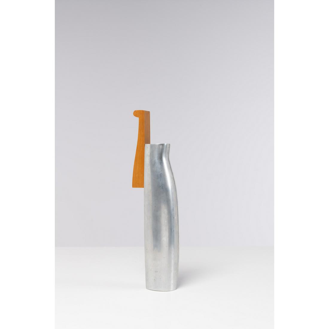 Eric Jourdan (born in 1961) Pitcher: Eric Jourdan (born in 1961)PitcherCast aluminum and beechwoodEdited by ArdiModel created in 1992H 36,5 × L 6 × W 9,5 cmExhibition: Seville world exposition, Spain, 1992Note: The buyer will b