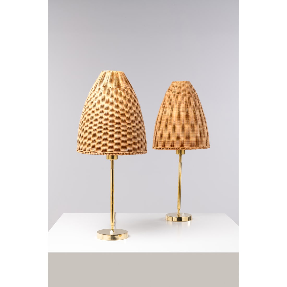 Maija Heikinheimo (1908-1963) Pair of lamps model no. 705: Maija Heikinheimo (1908-1963)Pair of lamps model no. 705Brass and rattanEdited by ValaistustyöStamped 'Valaistustyö' and '705'H 70 x D 31 cm