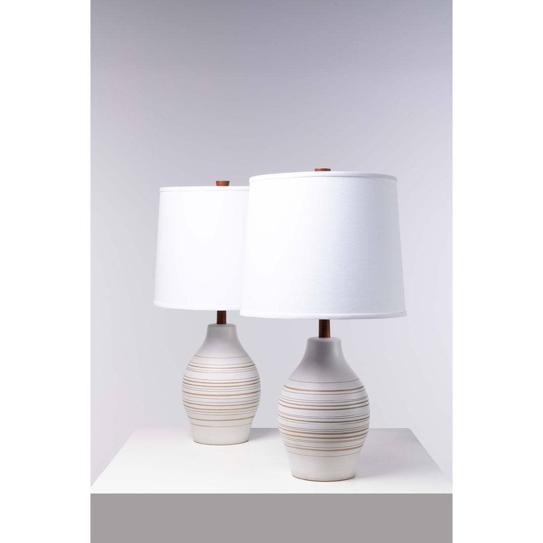 Jane & Gordon Martz (20th c.) Pair of table lamps: Jane & Gordon Martz (20th c.)Pair of table lampsWalnut, ceramic, brass and fabricEdited by Marshall StudiosSigned "Martz" on the baseModel created in the 1960sH 83 × Ø 45 cm