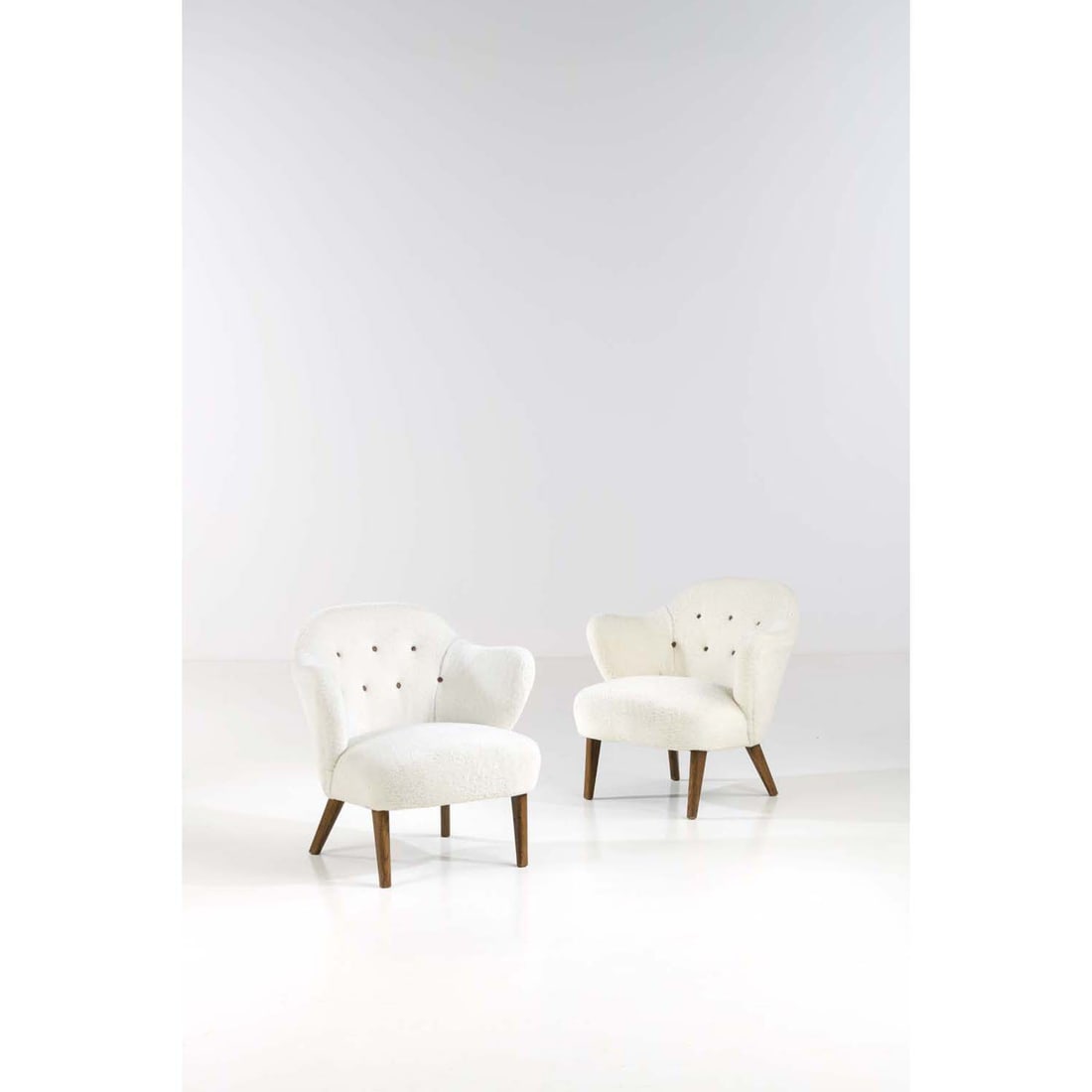 Flemming Lassen (1902-1984) Pair of armchairs Teak and fabric Edited by Jacob Kjaer Model created: Flemming Lassen (1902-1984) Pair of armchairsTeak and fabricEdited by Jacob KjaerModel created circa 1940H 77 × L 75 × W 61 cm