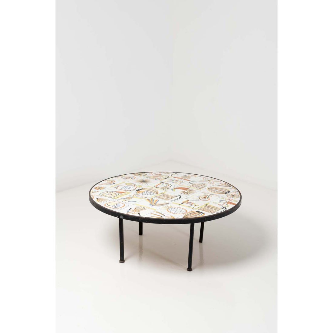 f Roger Capron (1922-2006): fRoger Capron (1922-2006)Coffee tableEnamelled ceramic and black lacquered metalSigned 'R CAPRON' on a tileModel created circa 1955H 40 x Ø 91 cm