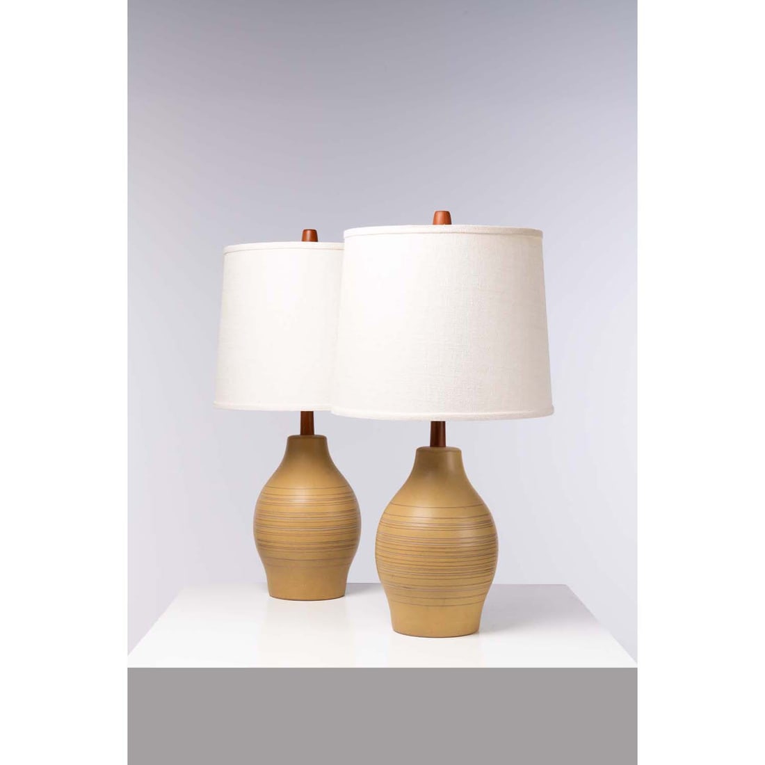 Jane & Gordon Martz (20th c.) Pair of table lamps: Jane & Gordon Martz (20th c.)Pair of table lampsWalnut, ceramic, brass and fabricEdited by Marshall StudiosSigned 'Martz' and manufacturer's label on the basesModel created in the 1960sH 83 × 