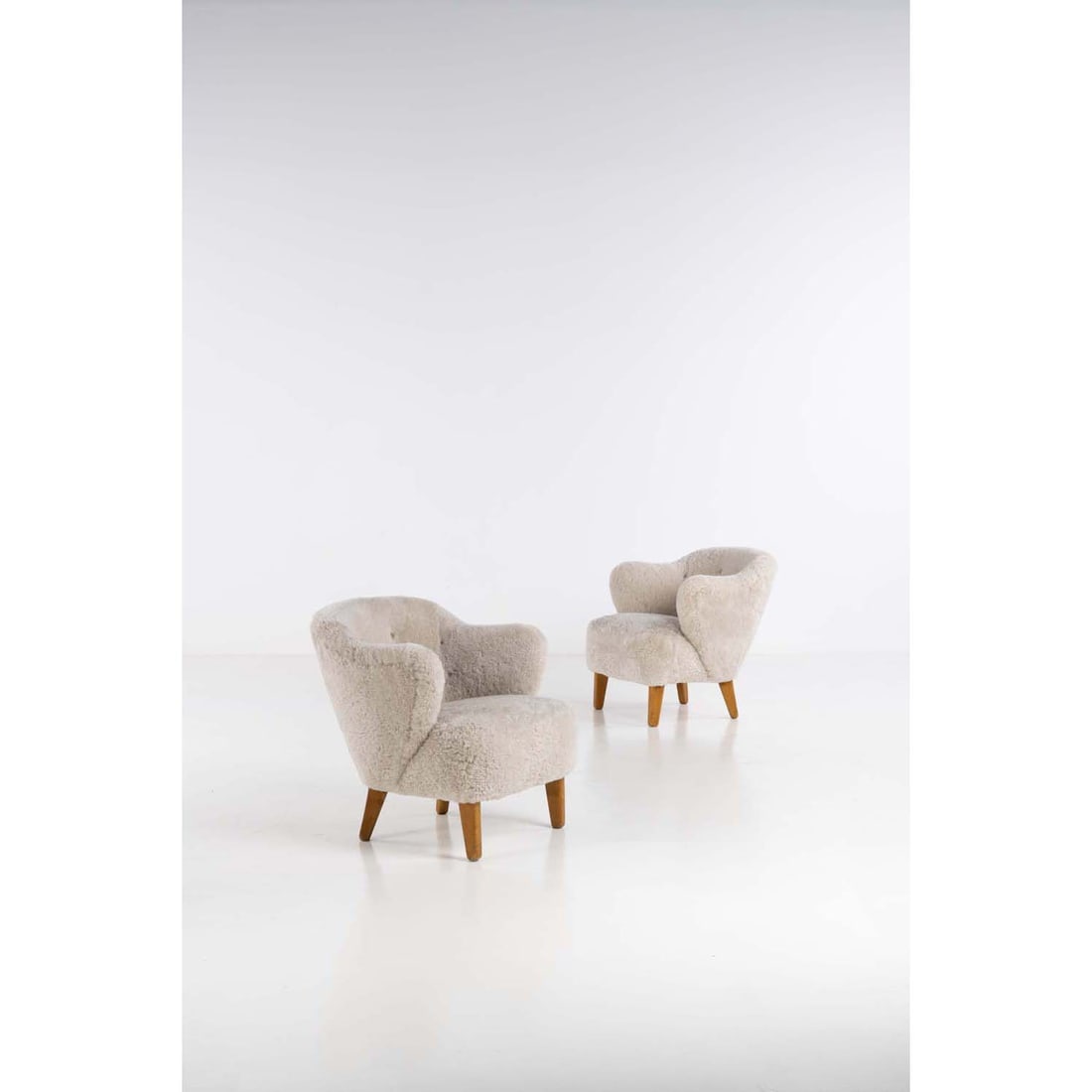 Flemming Lassen (1902-1984) Pair of armchairs: Flemming Lassen (1902-1984)Pair of armchairsAsh wood and fabricEdited by Jacob KjærModel created in the 1940H 73 × L 73 × W 73 cm