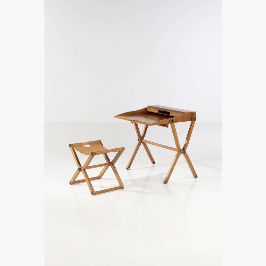 Rena Dumas (1937–2009) & Peter Coles (1955-1985) in collaboration with Hermès Pippa: Rena Dumas (1937–2009) & Peter Coles (1955-1985) in collaboration with HermèsPippaTravel desk and its folding stool Pear tree wood, leather and brassEdited by HermèsStamped with 'P.R.