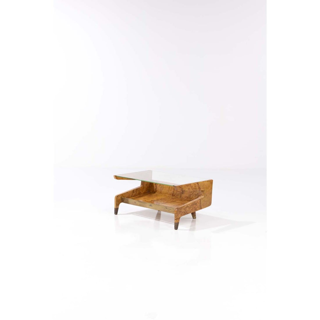 Gio Ponti (1891-1979) Coffee table – magazine rack: Gio Ponti (1891-1979)Coffee table – magazine rackElm burl (radica), brass and glassEdited by Giordano Chiesa, Milan, ItalyModel created circa 1951H 40,5 × L 86 × W 49 cmProvenance: Mod