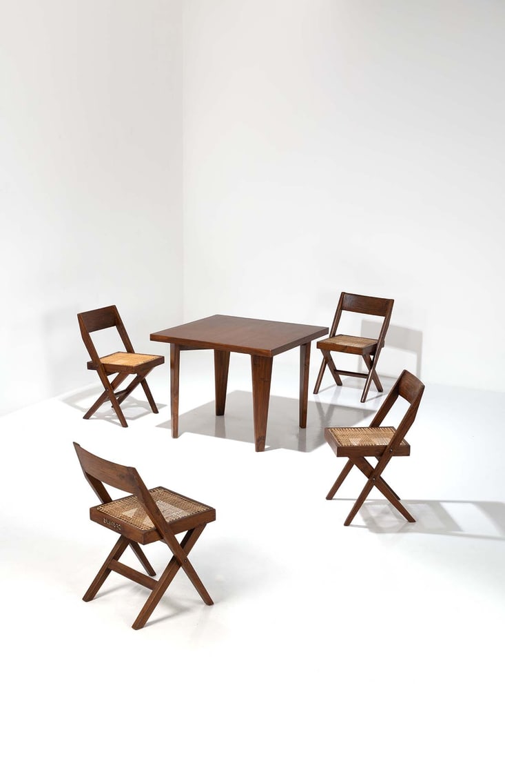 Pierre Jeanneret (1896-1967) Ensemble comprenant une table dite 'Square table' et une suite de: Pierre Jeanneret (1896-1967)Ensemble comprenant une table dite 'Square table' et une suite de quatre chaisesModèle dit 'Library chair'Teck et cannageUne chaise avec numéro d'inventaire peint