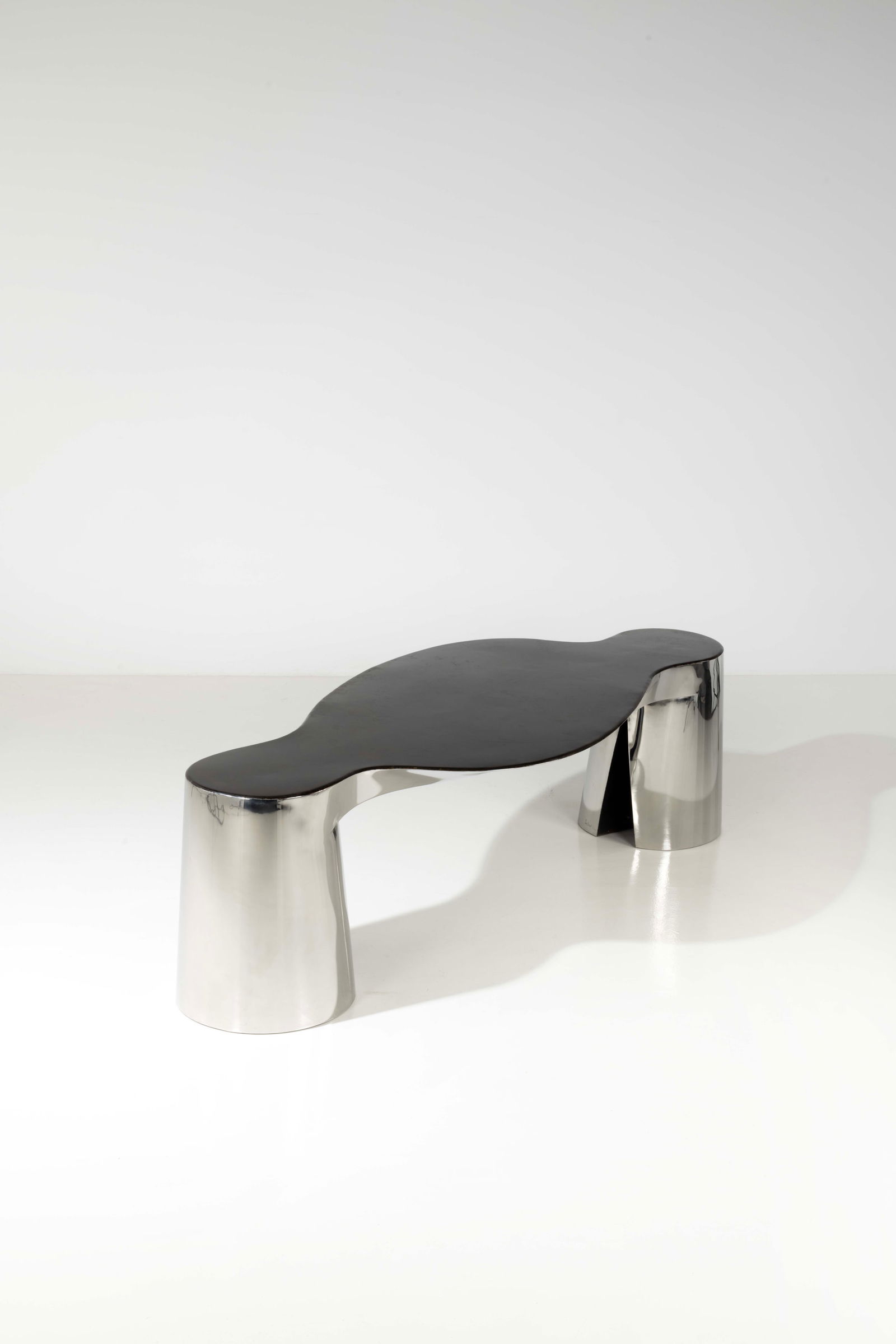 Ron Arad (born 1951) Table - 'Two legs and a table' model: Ron Arad (born 1951)Table - 'Two legs and a table' modelLimited editionPolished and patinated steelEdited by One Off Ltd., limited edition of 20, each uniqueSigned 'Ron Arad' and dated '1/95' on the f