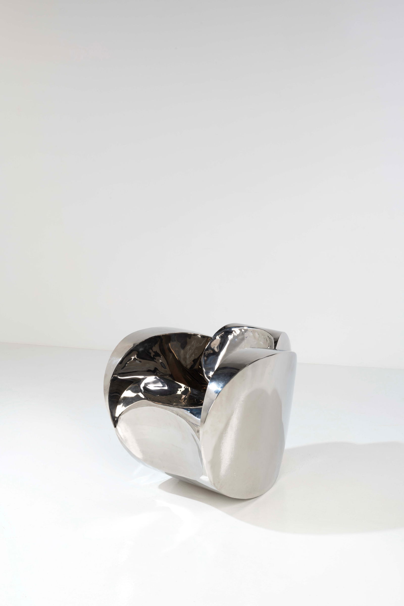 Ron Arad (born 1951) Armchair - 'Rolling Volume' model: Ron Arad (born 1951)Armchair - 'Rolling Volume' modelLimited editionPolished stainless steelEdited by Ron Arad Associates, limited edition of 20Model created in 1989H 75,5 × L 75 × W 97 cmBi