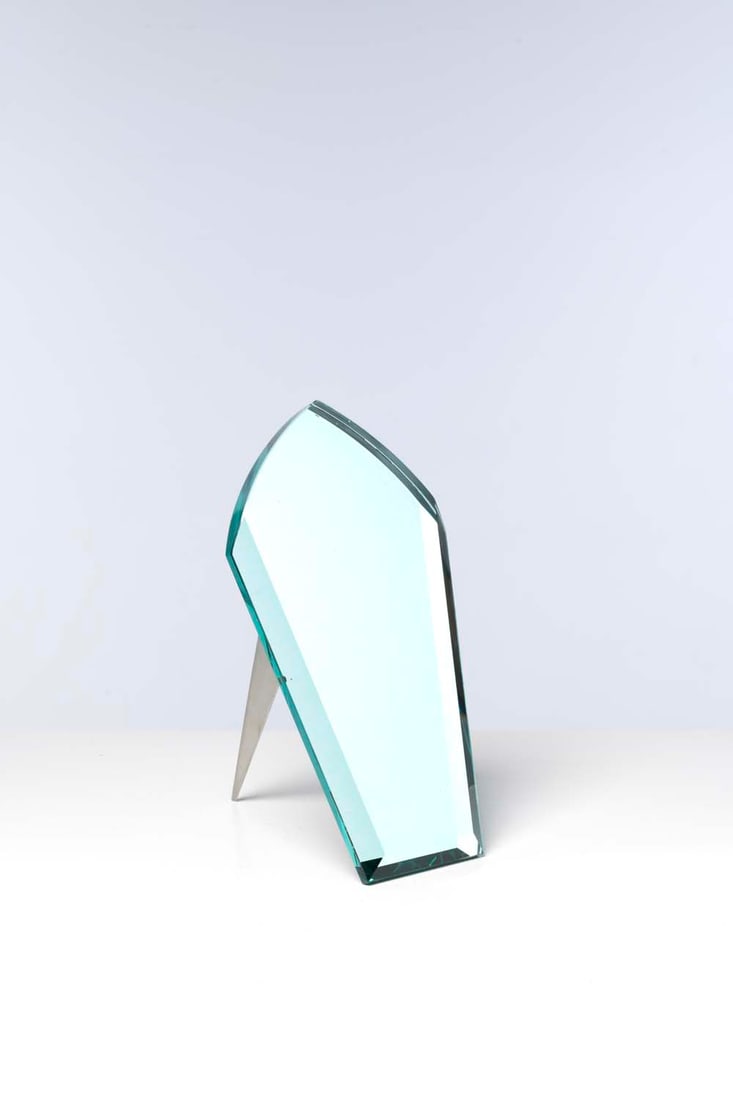 Philippe Starck (born 1949) Mirror: Philippe Starck (born 1949)MirrorGlass and steelModel created in 1988Editeur AlephH 35 x W 22 x D 27 cm
