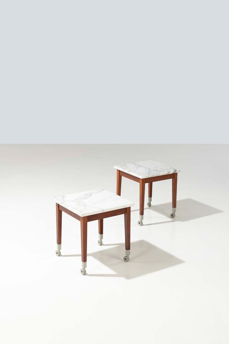 Philippe Starck (born 1949) Neoz: Philippe Starck (born 1949)NeozTwo rolling side tablesMarble and mahogany teinted woodModel created in 1995Driade editionH 42.5 x W 40 x D 40 cm