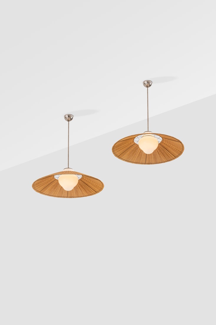 Gunilla Jung (1905-1939) Pair of ceiling lamps Metal, wood slats and glass Edited by Orno Stamped: Gunilla Jung (1905-1939)Pair of ceiling lampsMetal, wood slats and glassEdited by OrnoStamped with 'Melva'Model created circa 1935H 85 × Ø 74 cmBibliography: Orno commercial catalogue n°