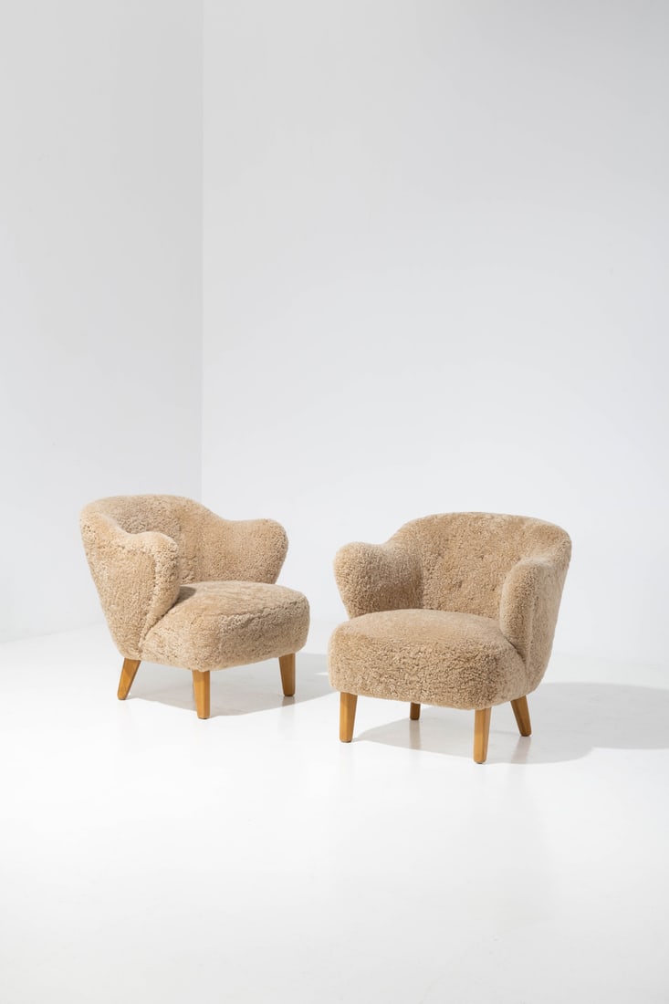 Flemming Lassen (1902-1984) Pair of armchairs: Flemming Lassen (1902-1984)Pair of armchairsAsh wood and fabricEdited by Jacob KjaerModel created in the 1940sH 76×L 80×W 73cm*H 75×L 75×W 80cmBibliography: 'Dansk Mobelkunst gennem 40 aar,Volume