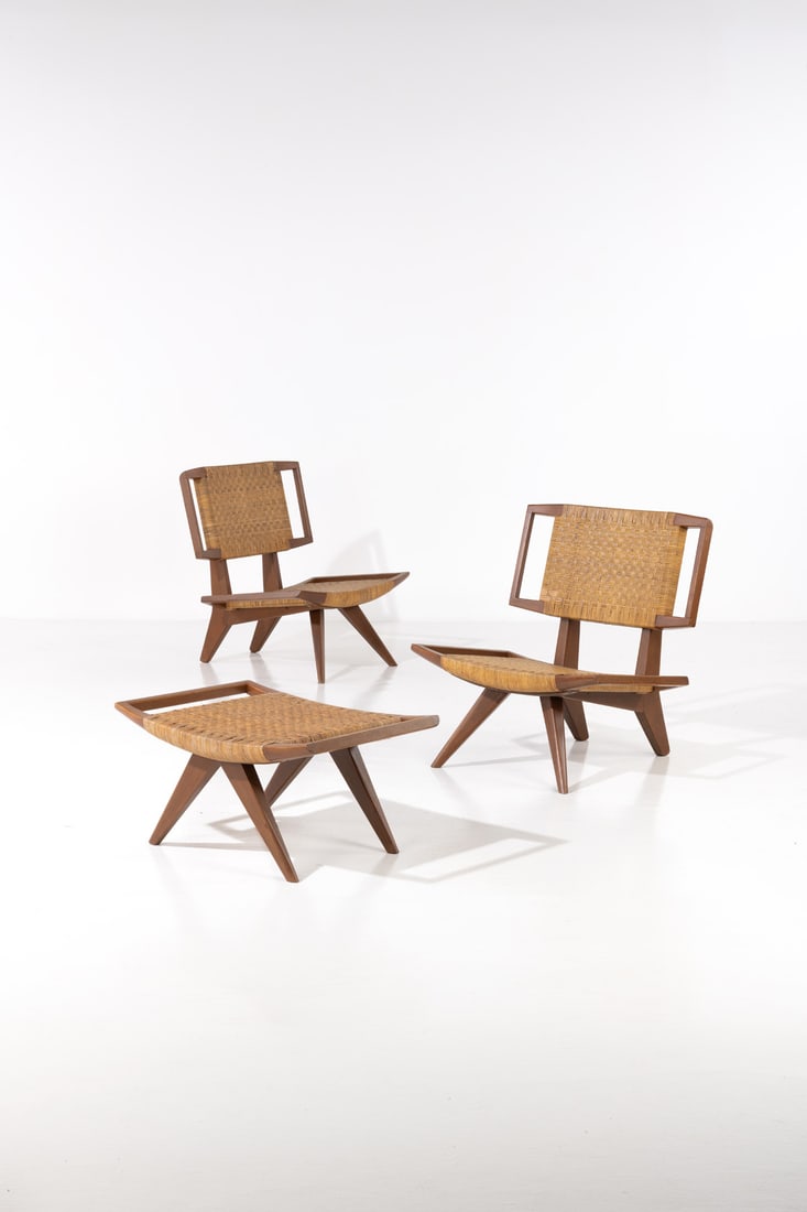 Paul Laszlo (1900-1993) Set of two armchairs and an ottoman: x Paul Laszlo (1900-1993)Set of two armchairs and an ottomanWalnut and rattanGlenn of California editionModel created in 1958H 84 x W 74 x D 70cm (armchair)H 38.5 x W 70 x D 53cm (ottoman)