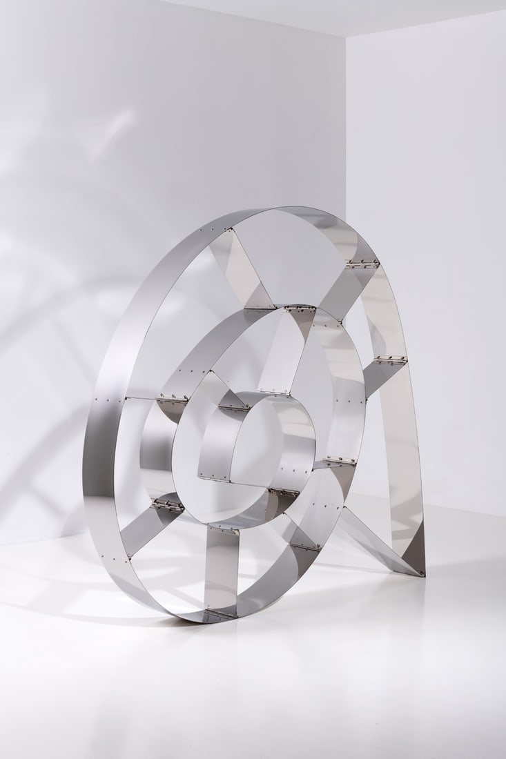 Ron Arad (born in 1951) Bookcase - Model 'This Mortal Coil' No: Ron Arad (born in 1951)Bookcase - Model 'This Mortal Coil' No.12/20Mirror-polished stainless steelRon Arad Studio edition, limited to 20 copies + 5 artist's proofsSigned 'R. Arad' and numbered '12/20'