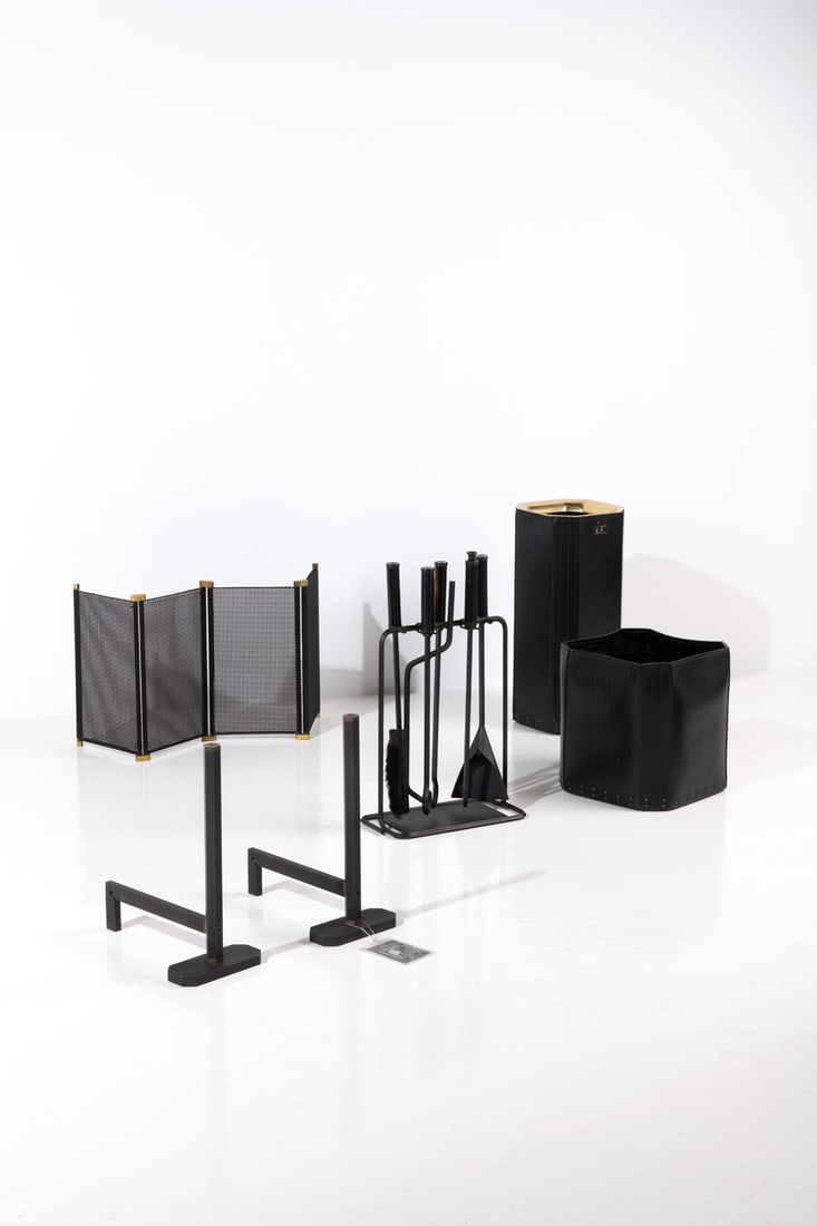 Afra (1937-2011) & Tobia Scarpa (born 1935) Fireplace set with: a pair of andirons, a log holder, an: Afra (1937-2011) & Tobia Scarpa (born 1935)Fireplace set with: a pair of andirons, a log holder, an umbrella stand, a fireguard, and five utensils Metal, wood, leather, cast metal and brassEdited by D