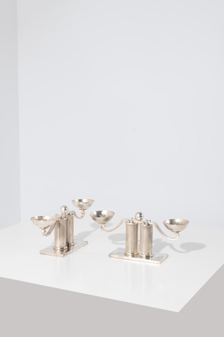 Jean Després (1889-1980) Pair of candle holders: Jean Després (1889-1980)Pair of candle holdersSilver-plated metalIncised signature, 'J. Després' on the undersideModel created circa 1950H 15 × L 35 × W 8,5 cm