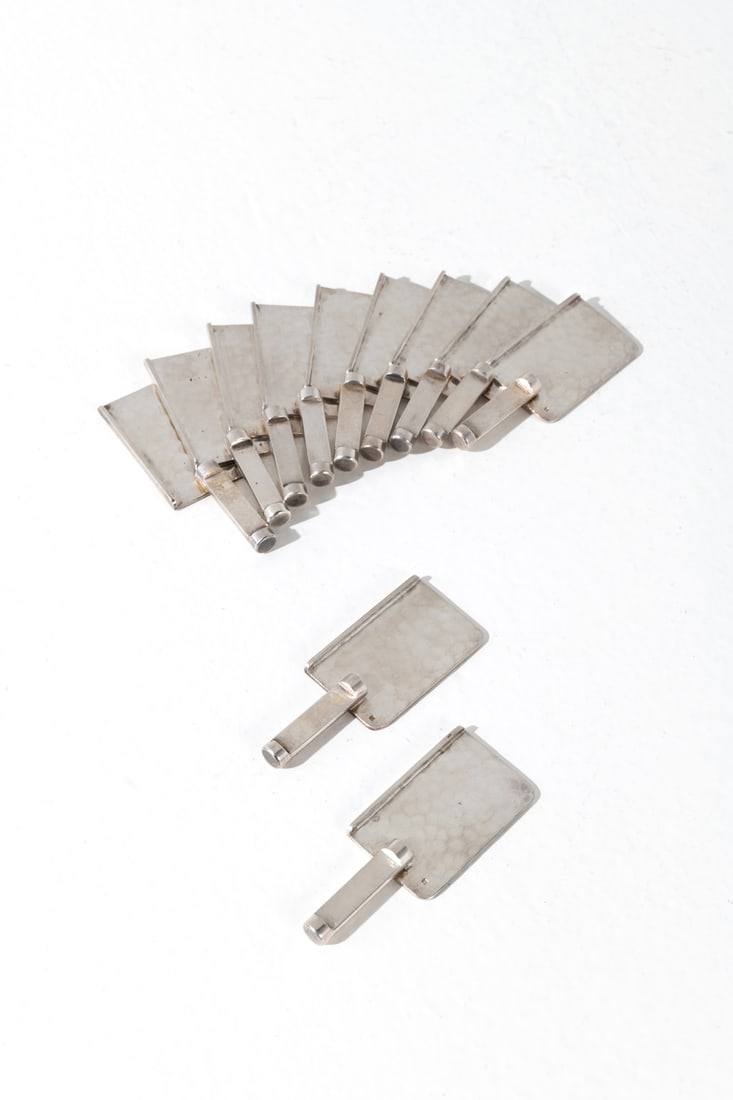 Jean Després (1889-1980) Set of eleven knife rests: Jean Després (1889-1980)Set of eleven knife restsSilver-plated metalSilversmith’s hallmark on eachModel created circa 1950H 0,6 × L 8 × W 3 cm