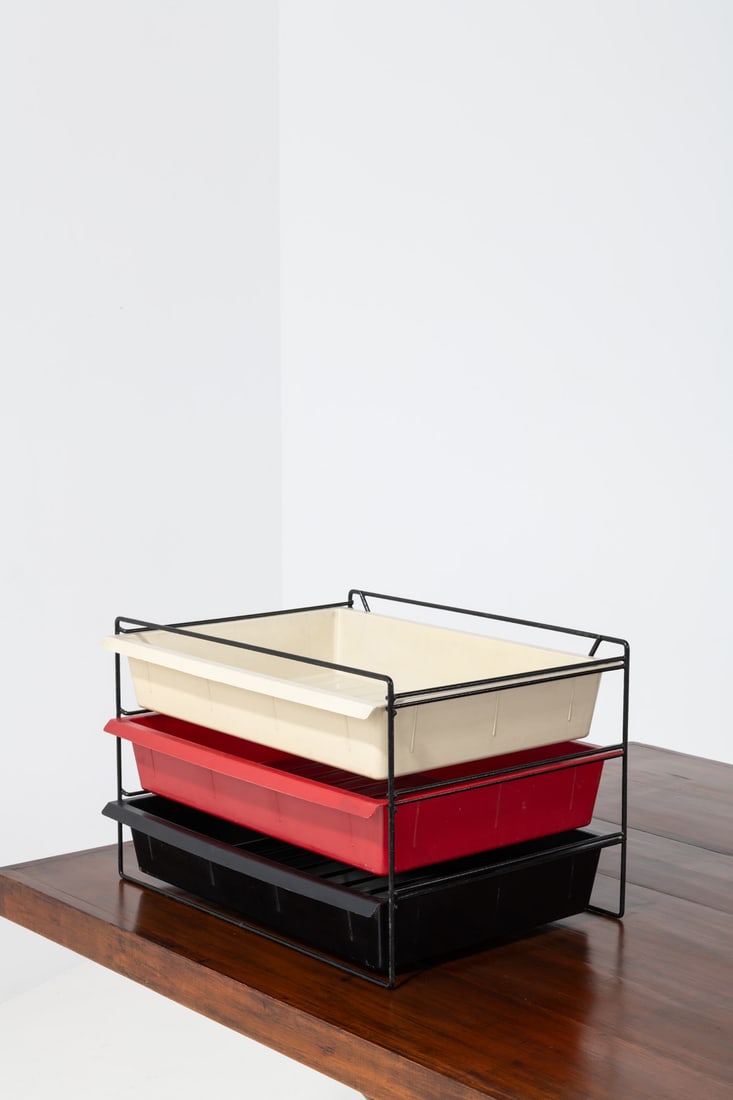 Charlotte Perriand (1903-1999) Three storage drawers: Charlotte Perriand (1903-1999)Three storage drawersMolded plastic and lacquered metalTwo drawers embossed with 'Modèle Charlotte Perriand breveté S.G.D.G'Model created in 1958H 33 × L 53,5 × W 37