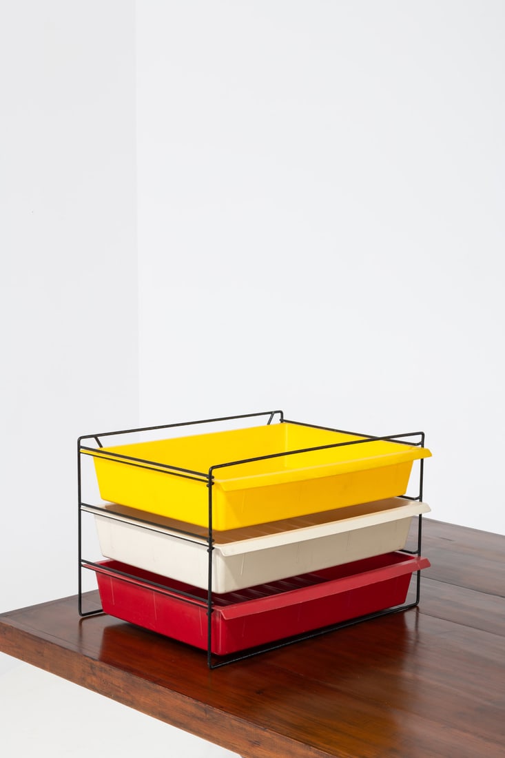 Charlotte Perriand (1903-1999) Three storage drawers: Charlotte Perriand (1903-1999)Three storage drawersMolded plastic and lacquered metalTwo drawers embossed with 'Modèle Charlotte Perriand breveté S.G.D.G'Model created in 1958H 33 × L 5