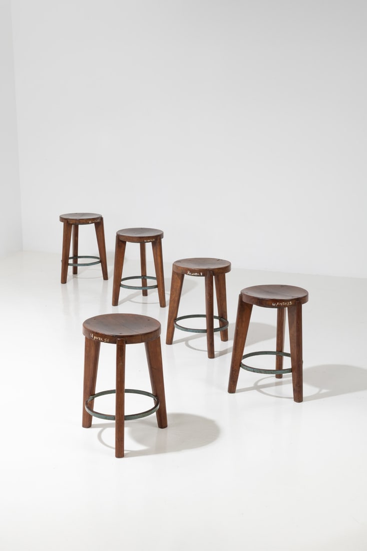 x Pierre Jeanneret (1896-1967) Set of five stools: x Pierre Jeanneret (1896-1967)Set of five stoolsTeak and metalPainted inventory numbers on eachModel created circa 1965H 51,5 × Ø 35 cmProvenance: Administrative buildings, Chandigarh, India