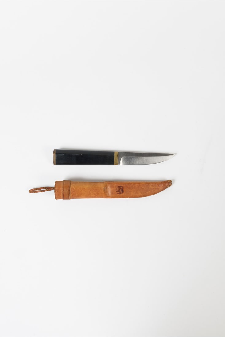 Tapio Wirkkala (1915-1985) Knife and sheath - 'Puukko' model: Tapio Wirkkala (1915-1985)Knife and sheath - 'Puukko' model Brass, horn, stainless steel, and leatherStamped on the sheath, signed on the blade Model created in 1977 L 24 cm