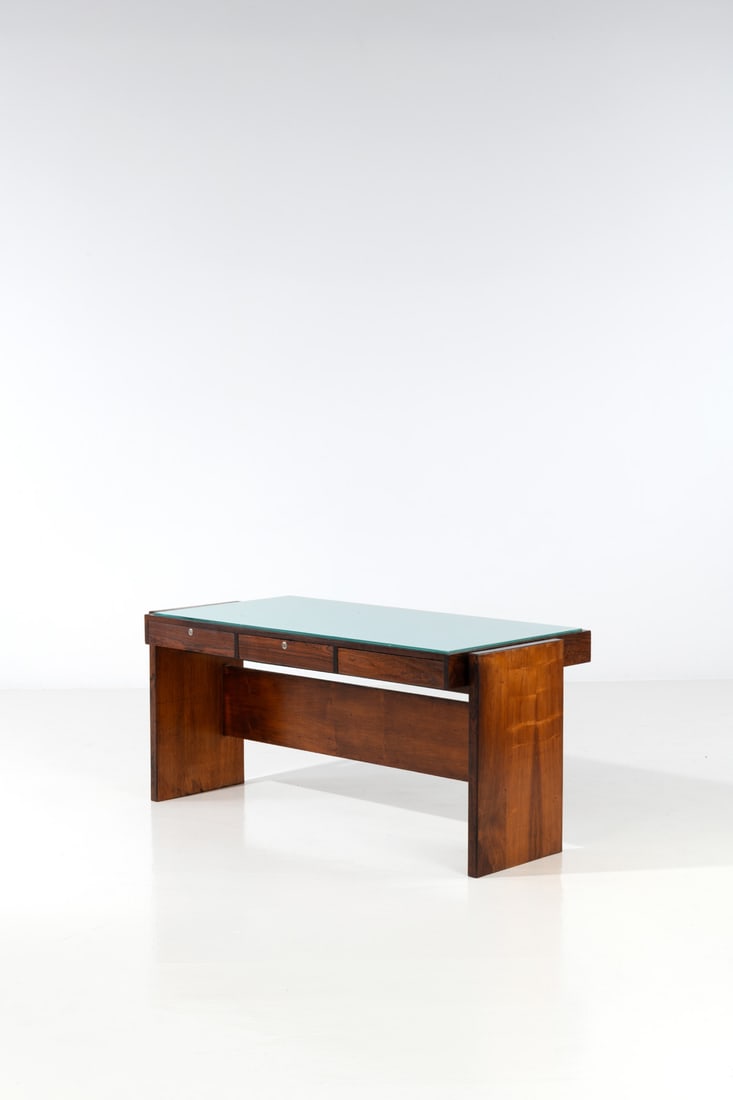 Joaquim Tenreiro (1906-1992) Desk: Joaquim Tenreiro (1906-1992)DeskImbuia veneer and lacquered glassEdited by Bloch EditoresPlaque 'Bloch Editores SA' numbered 891Model created circa 1965H 74 × L 150 × W 75 cm
