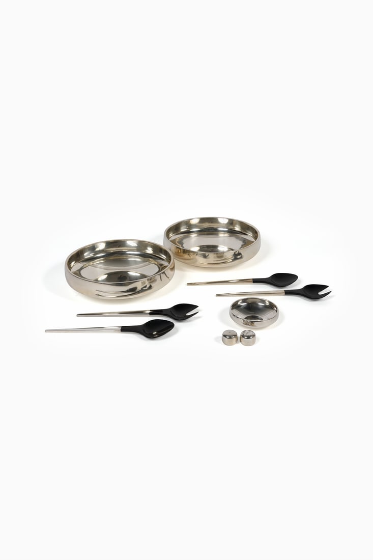 Henning Koppel (1918-1981) Two dishes, two pairs of serving utensils, a cup, and: Henning Koppel (1918-1981) Two dishes, two pairs of serving utensils, a cup, and salt and pepper shakers - Caravelle model Silver and melamine Edited by Georg Jenssen Silversmith’s hallmarks Mod