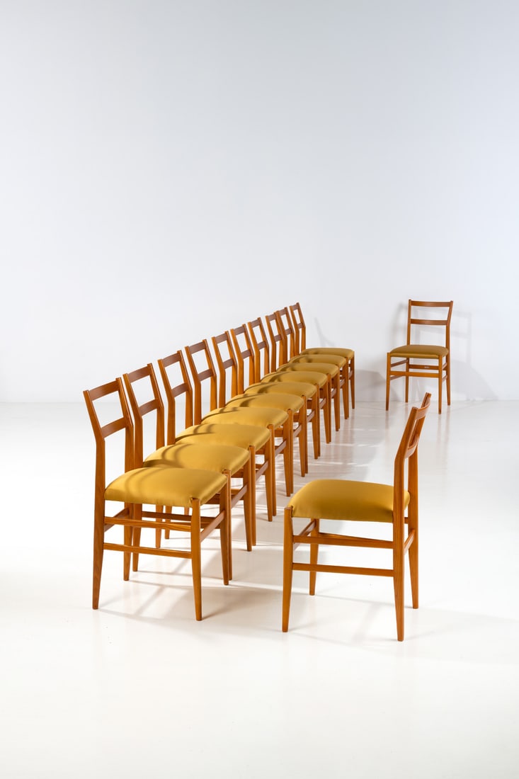 Gio Ponti (1891-1979) Set of twelve chairs - 'Leggera' Model: Gio Ponti (1891-1979)Set of twelve chairs - 'Leggera' ModelElm wood and fabricEdited by CassinaManufacturer’s labelModel created in 1955Production date: 1970sH 83 × L 43 × W 44 cm