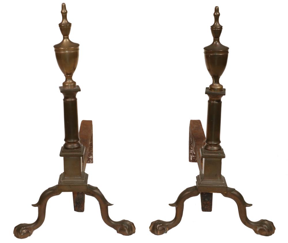 PR CHIPPENDALE ANDIRONS: Pair of Philadelphia Chippendale Brass Andirons, with double urn tops over square plinths, spurred legs with ball and claw feet, iron log holders, 21" high, 11 1/2" x 24". Minor surface rust on log ho