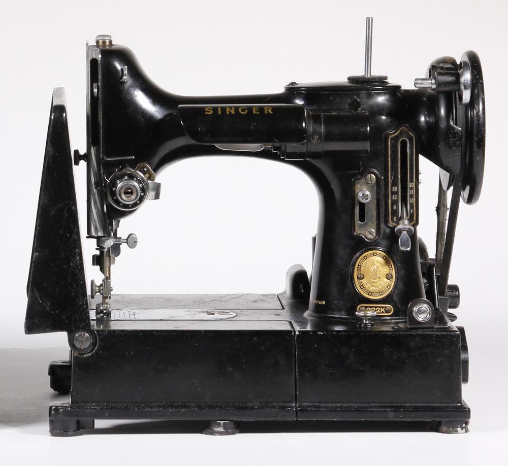 CASED SINGER SEWING MACHINE: Vintage Singer Featherweight Model 221K Portable Sewing Machine, (sn EJ908610), shows some wear consistent with age and use, includes varied accessories (bobbins, needles, lubricant). Case wear and so