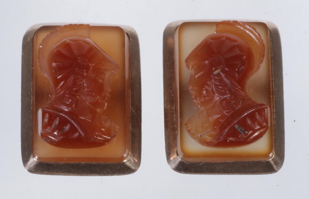 PR CARNELIAN AND ROSE GOLD CUFFLINKS: Pair of Carved Carnelian Cameo Form Cufflinks, depicting soldiers, with 14K rose gold frames, c. 1870. 5/8" long, 3/8" wide.