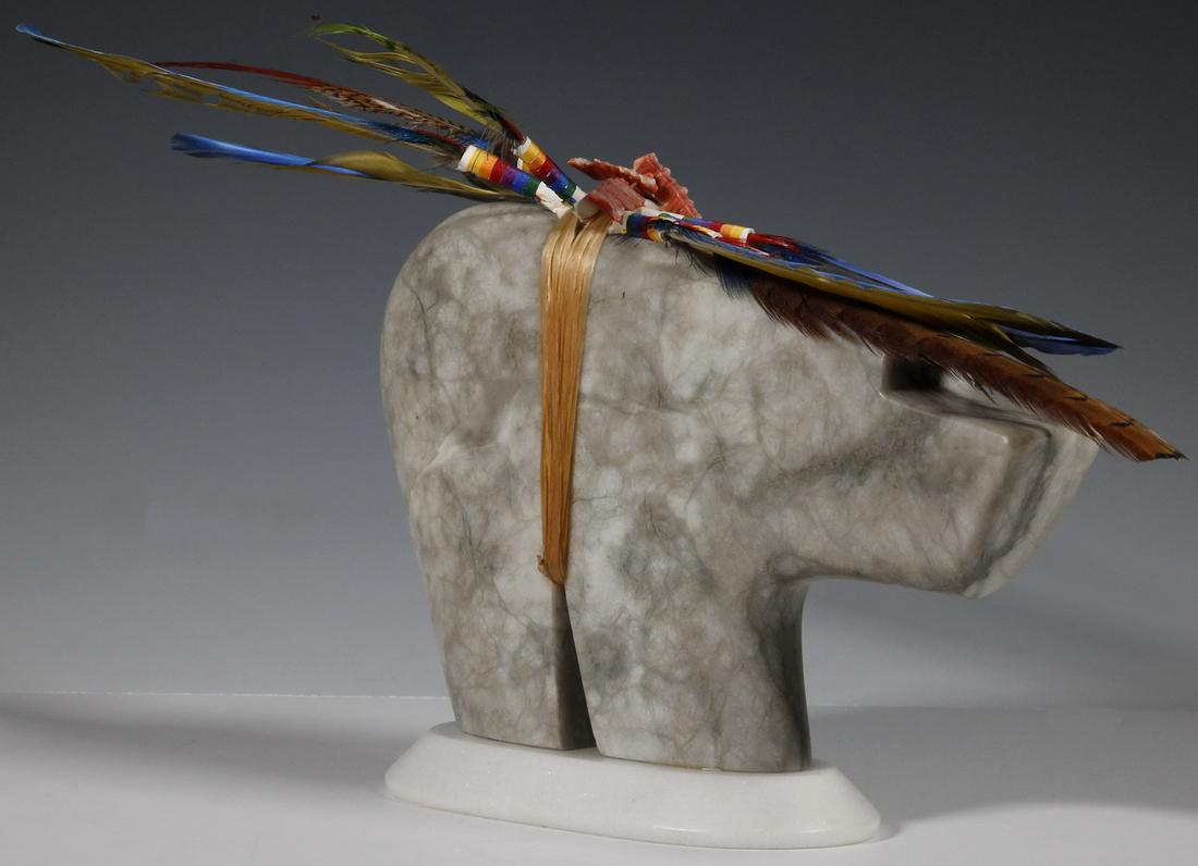 LANCE YAZZIE (US, 20TH/21ST C.) SCULPTURE: Silver Bear Fetish with Feathers, carved alabaster with white marble base, by Navajo Sculptor Lance Yazzie, etched signature 'L T Yazzie' to back leg just above base, symbolizing courage, protection a