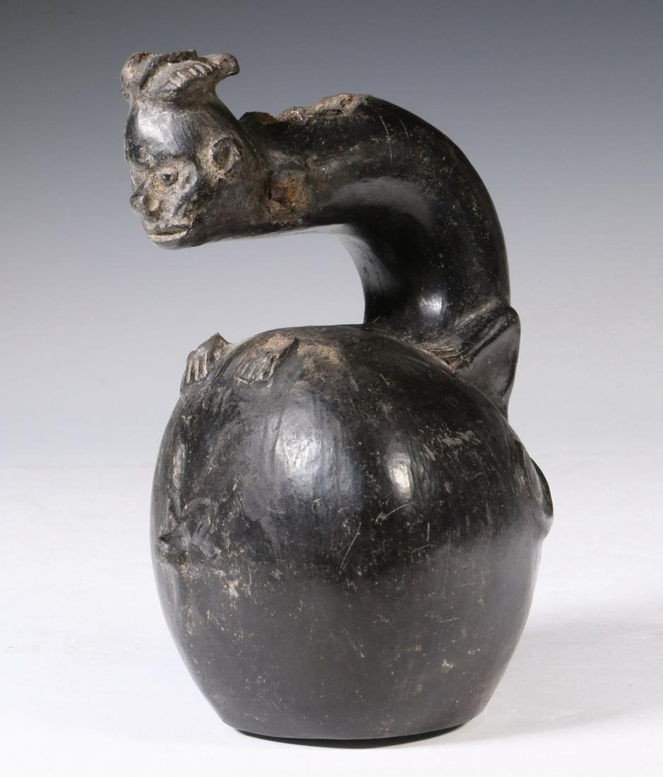 PRE-COLUMBIAN POTTERY: Chimu Inca Blackware Vessel with zoomorphic transformational handle, 1100-1500 AD, Peru ovoid, having a stirrup handle at top in the form of a monkey with man's head, 6 1/4" tall. Missing front legs, 
