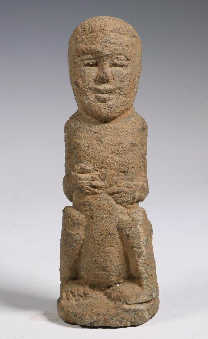 CONTINENTAL INDIAN GREENSTONE CARVING: Naga Effigy Carving of a Squatting Man, in coarse greenstone, 6 3/4" tall. Encrusted, water stained.
