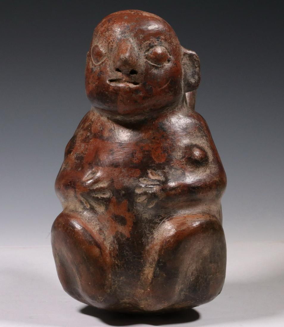 PRE-COLUMBIAN POTTERY: Seated Figure Vessel, Moche, Inca, 100-500 CE, with stirrup spout, terra cotta with black decoration, 7 1/4" tall. Good condition.