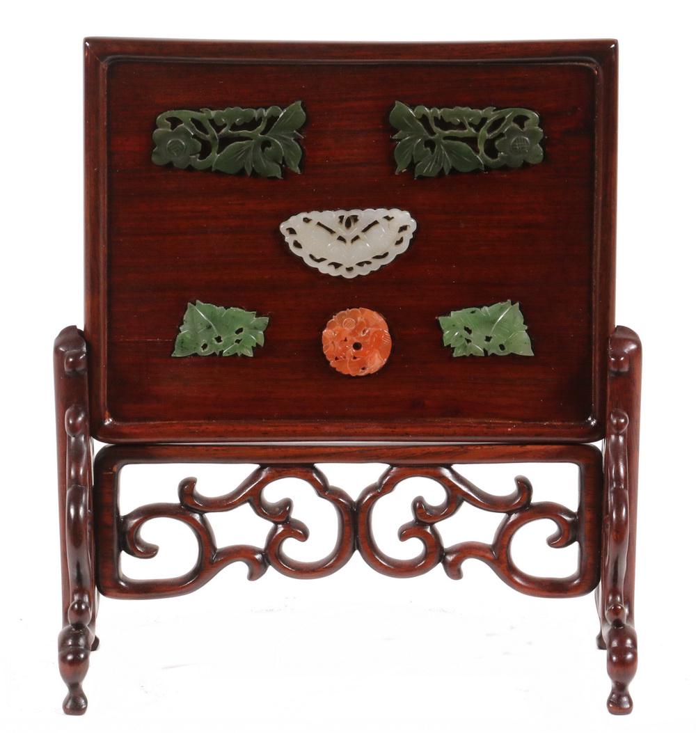 MINIATURE CHINESE TABLE SCREEN: Rectangular Rosewood Screen having five jade inserts, set into a reticulated scrollwork trestle base resting on four feet. 7 3/4" x 6 3/4" x 3". Good condition. Screen slides out of stand.