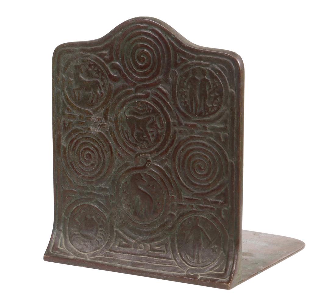 TIFFANY STUDIOS 'ZODIAC' BRONZE BOOKEND: Single Early 20th c. 'Zodiac' Pattern Bronze Bookend by Tiffany Studios, in patinated bronze with verdigris highlights, marked on base "Tiffany Studios, New York, 1091", 5 3/4" high, 5" x 5". Minor su