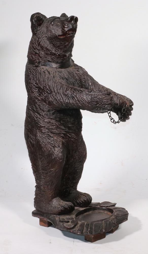 BLACK FOREST STYLE FIGURAL UMBRELLA STAND: Replica Cast Resin Standing Bear Cub on platform base, positioned with arms outstretched and bridged by a length of chain, to hold umbrellas and canes, 33 1/2" x 16 1/2" x 13 1/2". Good condition.
