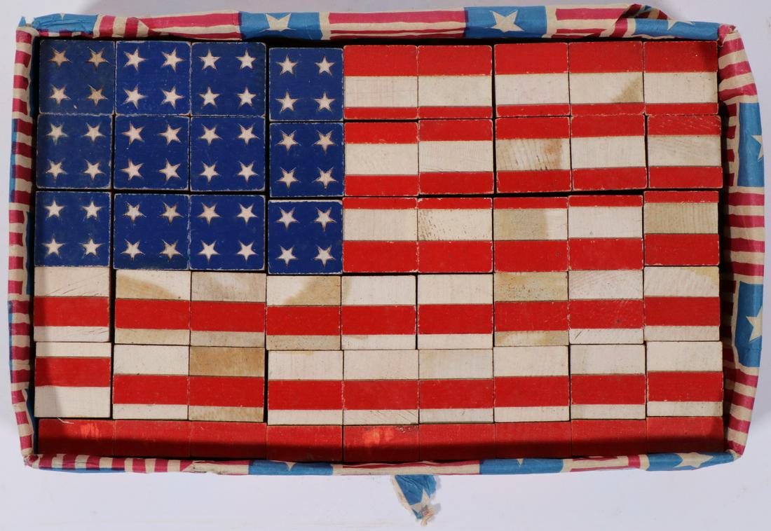 CHILD'S BLOCK SET, US FLAG, CIRCA 1940: 54-block set, assembling to represent a 48-star flag, presented in a later flag tissue wrapped cardboard tray, 2" x 12 1/2" 8". Good condition.