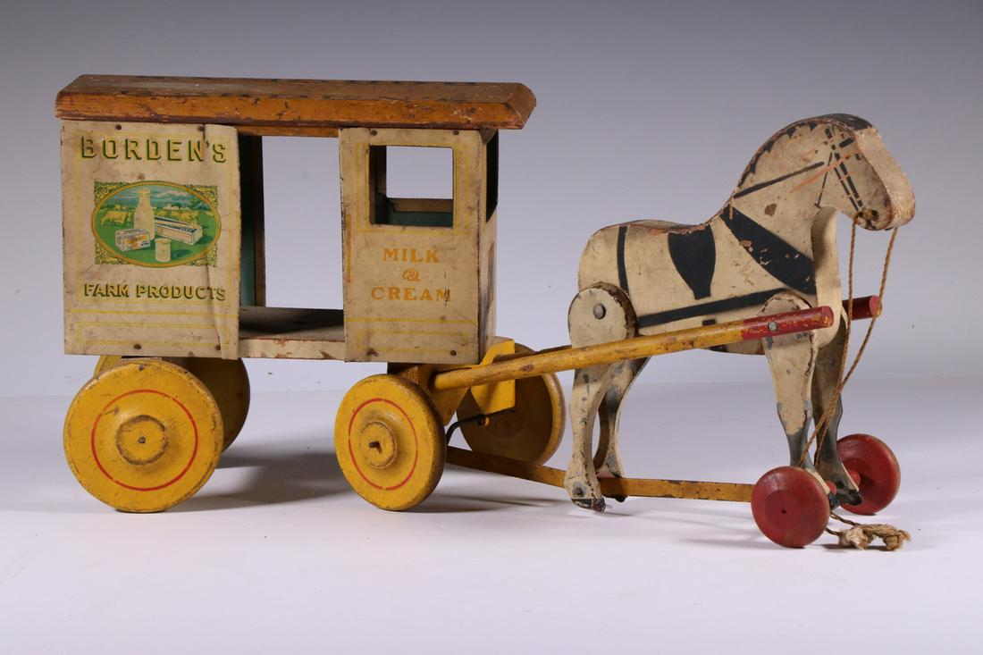 EARLY BORDEN'S MILK WAGON PULL TOY: Circa 1930 Painted Wood and Metal Pull Toy in the form of a Borden's Milk horse drawn wagon, manufactured by Rich Toys, Morrison, IL, 8 3/4" high, 19" long. Paint losses, minor dents.
