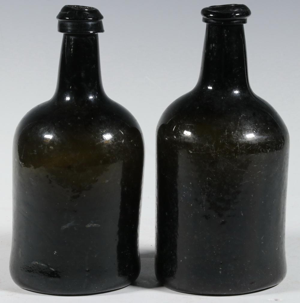 PR 18TH C. WINE BOTTLES: Pair of 18th c. English Mallet Form Wine Bottles, in olive green blown glass, pushed in base with large pontil marks, 8 1/2" high, 4" diam. Glass imperfections, base scratches.