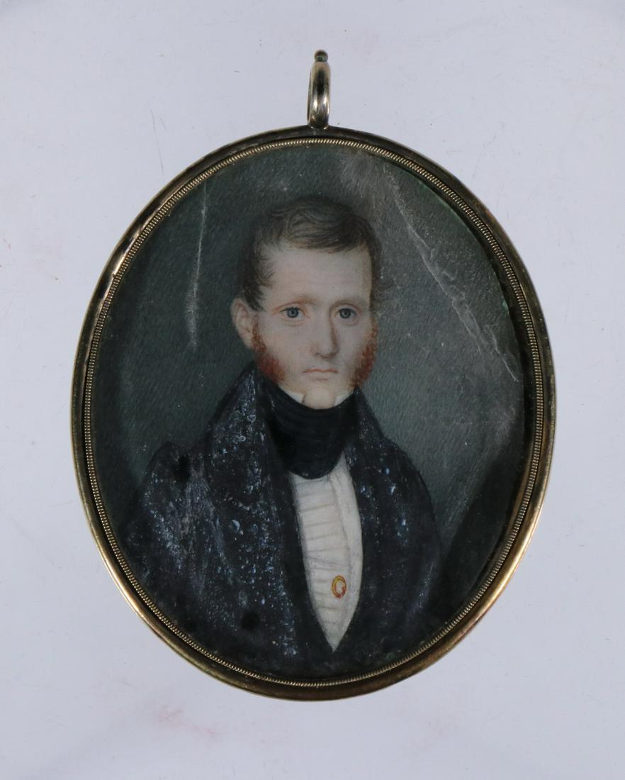MINIATURE PORTRAIT OF MAN: Portrait of a red-haired man with sideburns in a black stock, housed in a gold filled locket with brown hair reliquary on back, missing hair, 2 3/4" x 2 1/4". Lines in sky.
