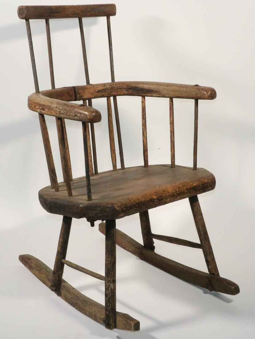 PRIMITIVE ROCKING CHAIR: Early Oak Rocking Chair with Iron Spindles, traces of black paint on surface, with assorted hardware and make-do repairs, 33" high, 21" x 25 1/2". Arm shrinkage crack, surface wear, rusted hardware, l
