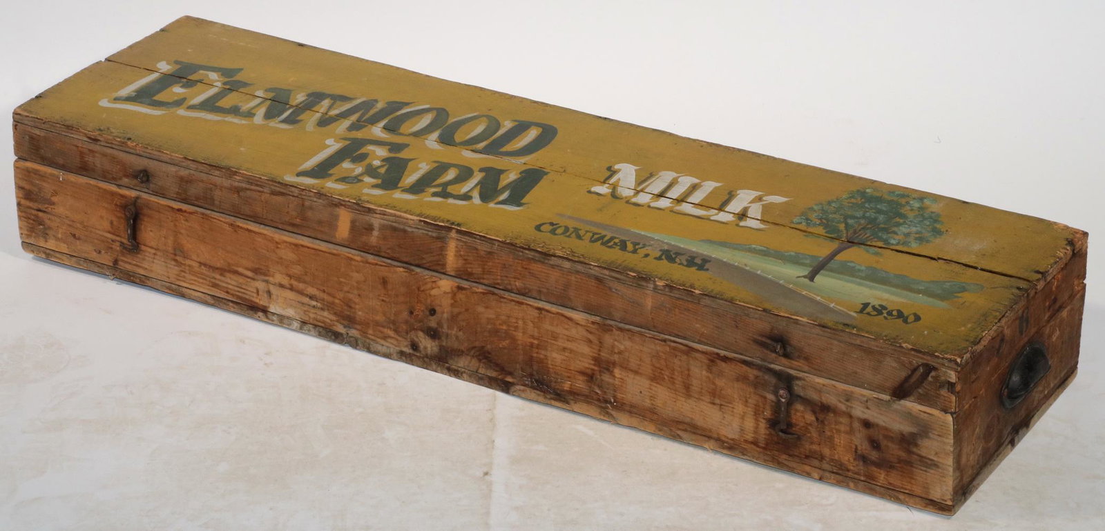 PAINTED WOODEN CRATE: Late 19th c. Long Low Pine Crate with iron handles, hinges and latches, the top painted "Elmwood Farm, Milk, Conway NH, 1890", 7" x 40" x 11". Good condition.